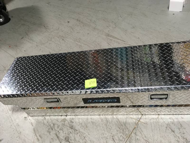 lot 80 image: Lund 51.5 in Diamond Plate Aluminum Full Size Crossbed Truck Tool Box SEE PHOTO DAMAGE