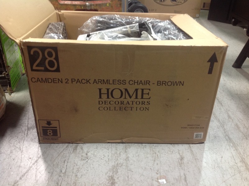 lot 115 image: Home Decorators Camden Dark Brown Wicker Outdoor Armless Dining Chair with Sunbrella Fretwork Flax Cushion (2-Pack) not used