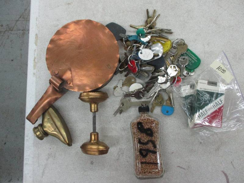 keys, bottle,brass door knobs, brass garden hose sprayer, brass pan with lid, half and half cig packages