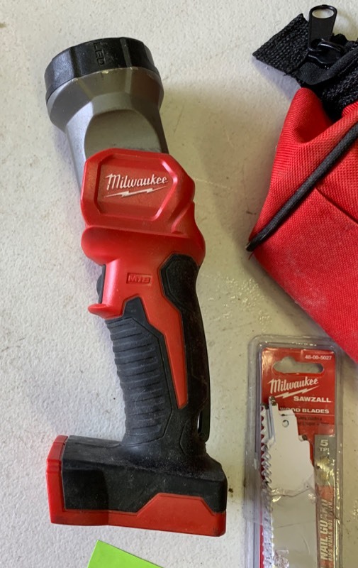 lot 65 image: Milwaukee lot- Untested AS IS - LED Work light,  battery charger, saw blades and carry case
