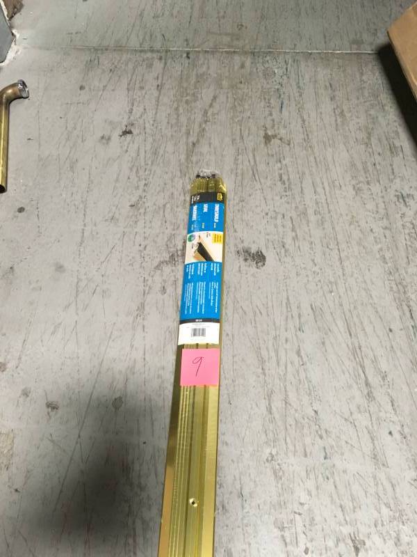 lot 9 image: M-D Building Products 72 in. Bright Gold Deluxe Low Aluminum Threshold with Vinyl Seal not used