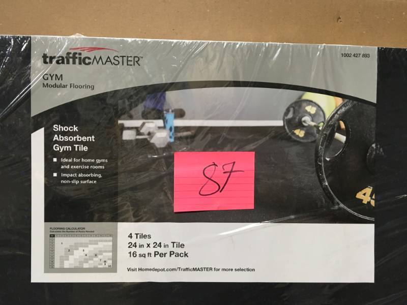 lot 87 image: TrafficMASTER Black 25.4 in. x 25.4 in x 0.68 in. Shock Absorbing Gym Floor (4-Pack) not used