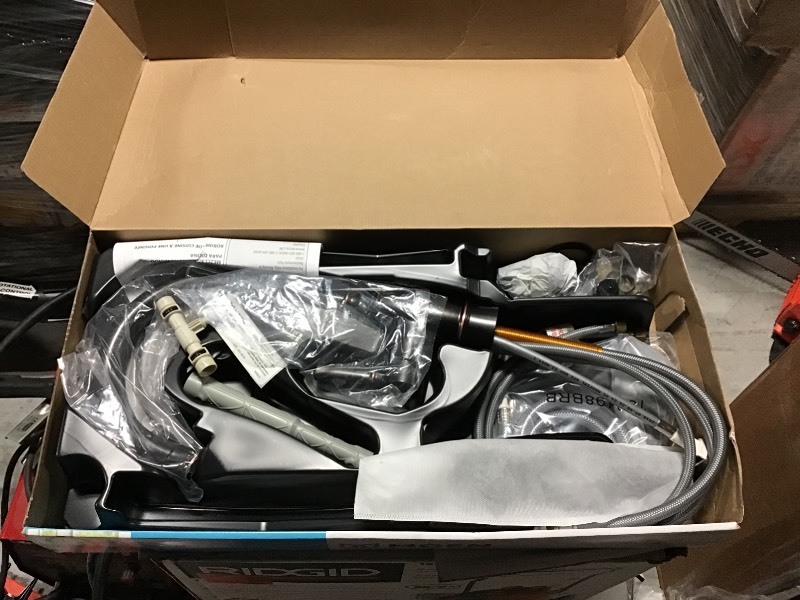 lot 103 image: MOEN Noell Single-Handle Standard Kitchen Faucet with Side Sprayer in Mediterranean Bronze in good conditions