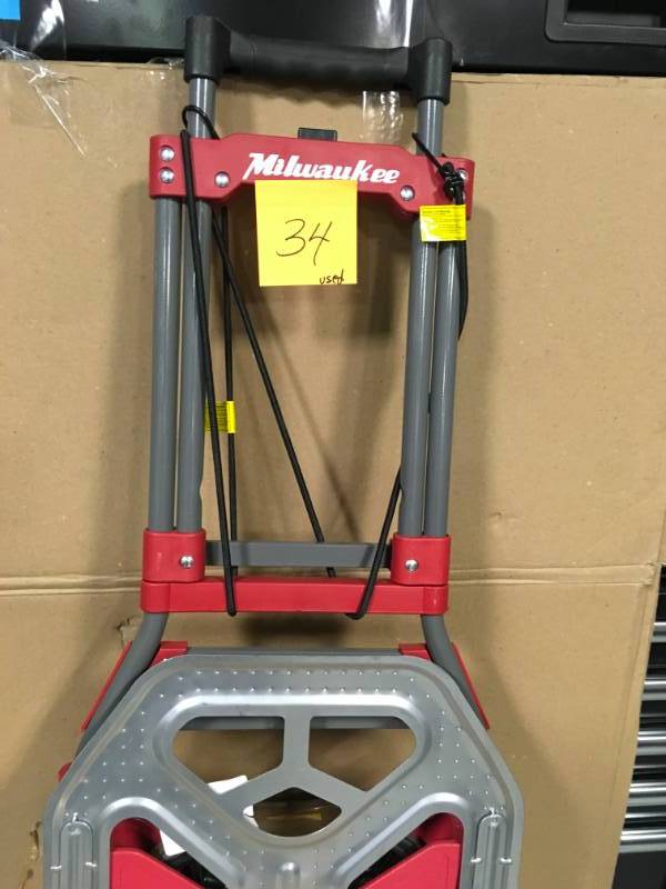lot 34 image: Milwaukee 150-lb 2-Wheel Red Steel Folding Hand Truck USED in good condition