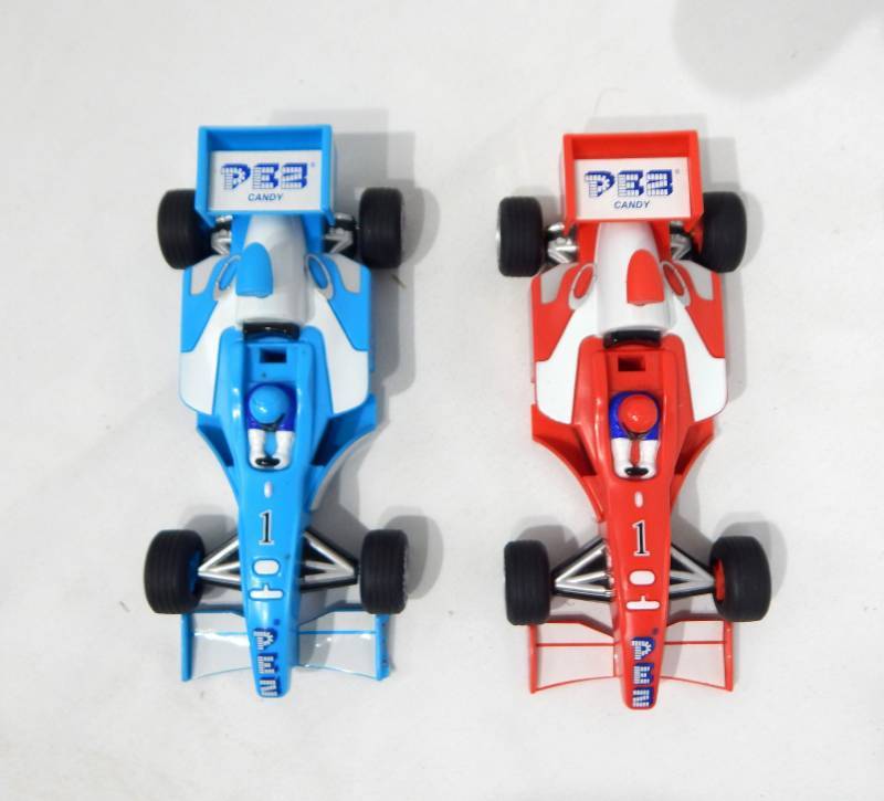 lot 99 image: Pair of Indy Car Pez Dispensers