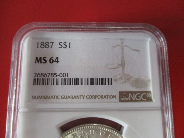 lot 3-11 image: NGC Certified 1887-P (Philadelphia Mint) Morgan Silver Dollar in Mint State 64 Condition.