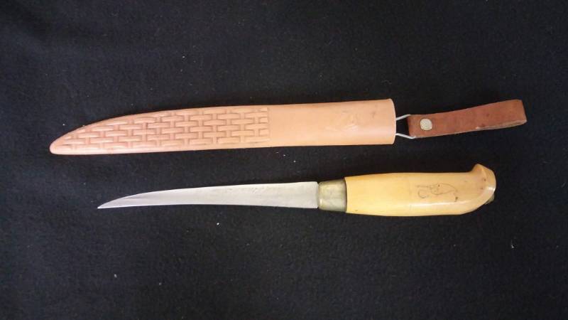 lot 14 image: Miscellaneous Ice Shoe Cleats, Hook Remover, Rapala Filet Knife, Ice Scoop, Spearing Decoy