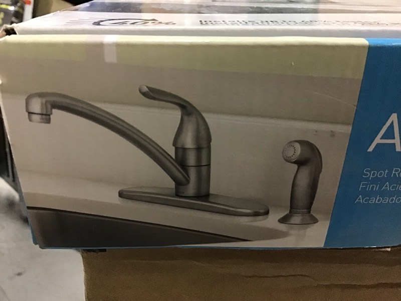 lot 104 image: Moen Adler Single-Handle Low Arc Standard Kitchen Faucet with Side Sprayer in Spot Resist Stainless in very good condition