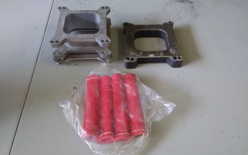 lot 43 image: 2-Carb Spacers, 4-Spark Plug Wire Protectors