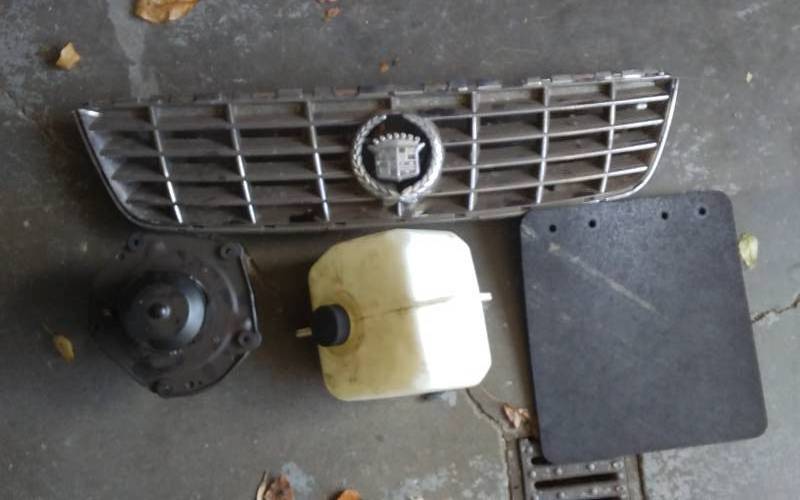 lot 46 image: Cadillac Grill, GM Heater Fan, Tank, Mud Flap