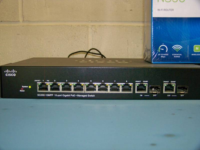 lot 41 image: (2) NEW Linksys N300 Routers and (2) Cisco Switches