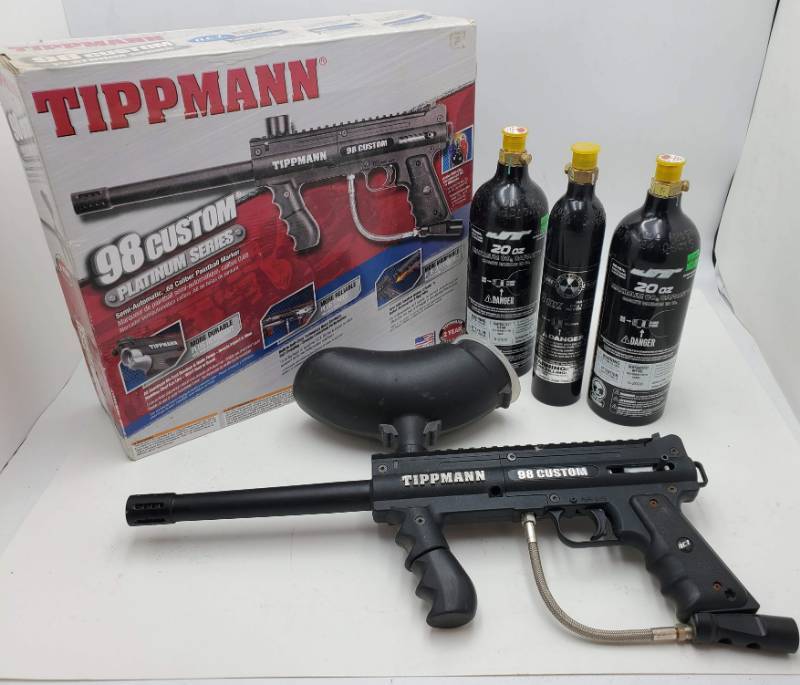 lot 62 image: Tippmann Paintball Gun w 3 unopened Bottles