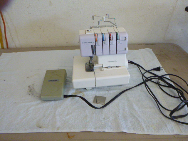 lot 45 image: New Home My Lock Serger Sewing Machine