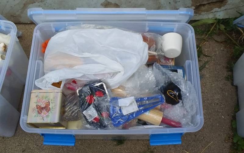 lot 55 image: Sterilite 54-Qt Gasket Bin With Lid & Unknown Wrapped Contents