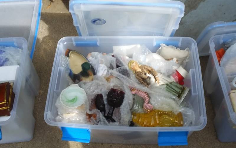 lot 56 image: Sterilite 54-Qt Gasket Bin With Lid & Unknown Wrapped Contents