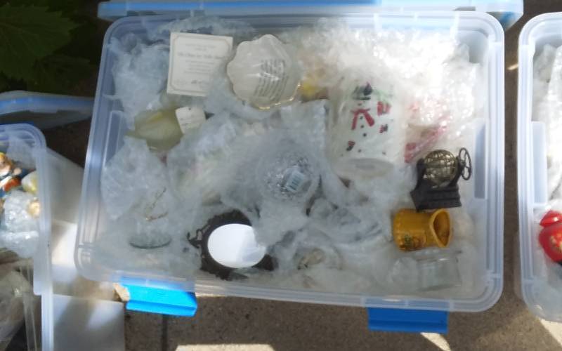 lot 60 image: Sterilite 54-Qt Gasket Bin With Lid & Unknown Wrapped Contents