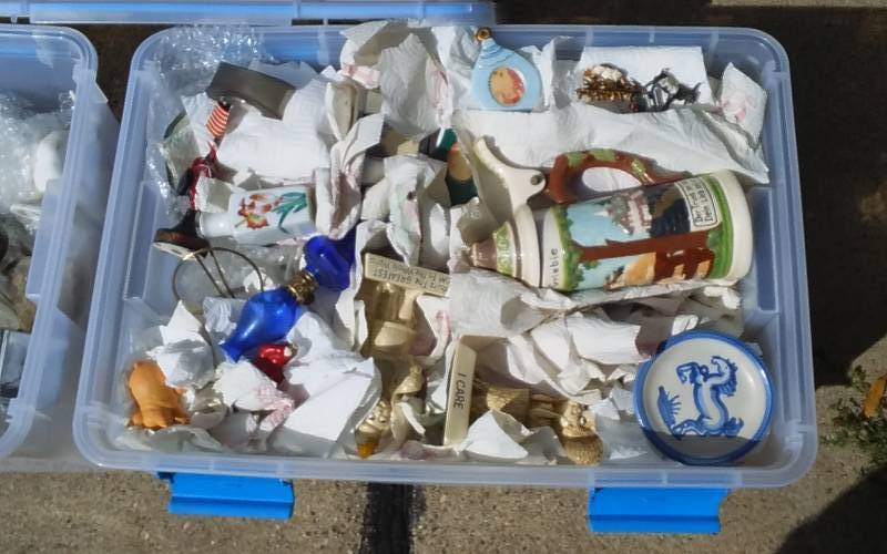 lot 62 image: Sterilite 54-Qt Gasket Bin With Lid & Unknown Wrapped Contents