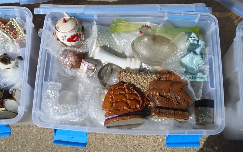 lot 64 image: Sterilite 54-Qt Gasket Bin With Lid & Unknown Wrapped Contents