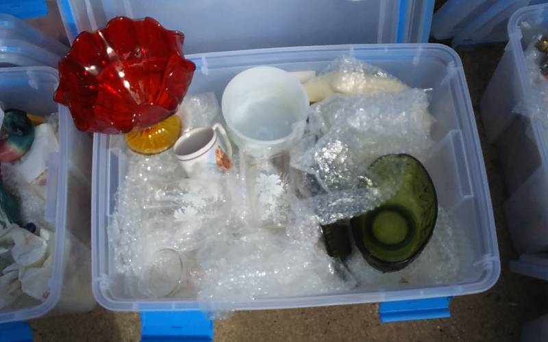 lot 67 image: Sterilite 54-Qt Gasket Bin With Lid & Unknown Wrapped Contents