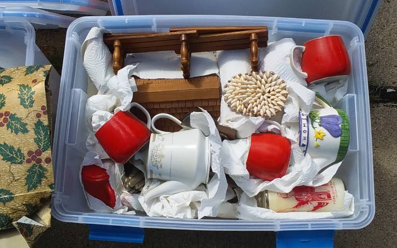 lot 70 image: Sterilite 54-Qt Gasket Bin With Lid & Unknown Wrapped Contents