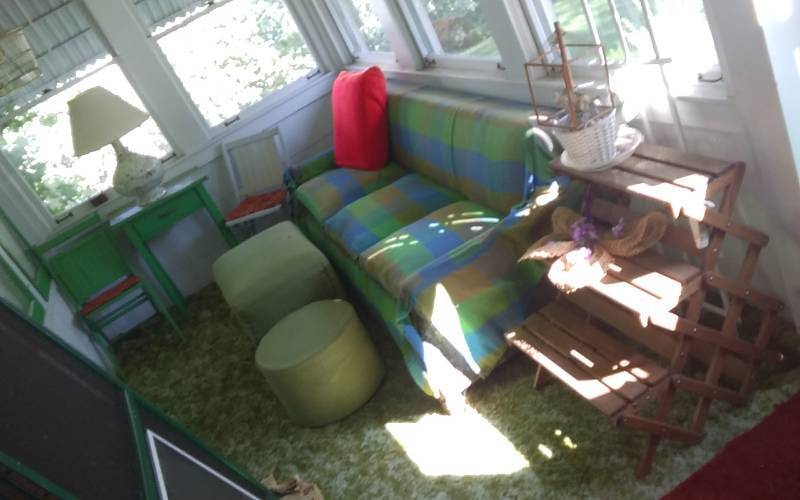 lot 117 image: Lot Of Vintage Furniture On The Porch-Sofa, Ottomans, Desk, Lamp, Folding Chairs, Plant Stand, Misc