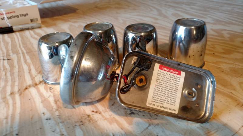 lot 37 image: 4 hub covers and antique spotlight eveready sealed lantern