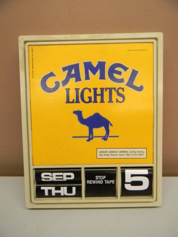 lot 16 image: VINTAGE CAMEL LIGHTS ADVERTISING SIGN CALENDAR - WORKS - APPROX 10 BY 12 - SEE PICTURES