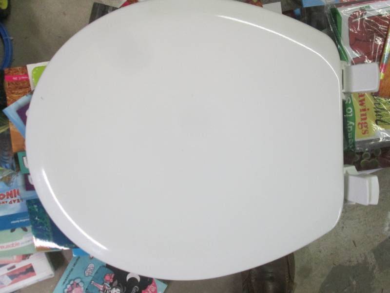 lot 220 image: toilet seat open package...