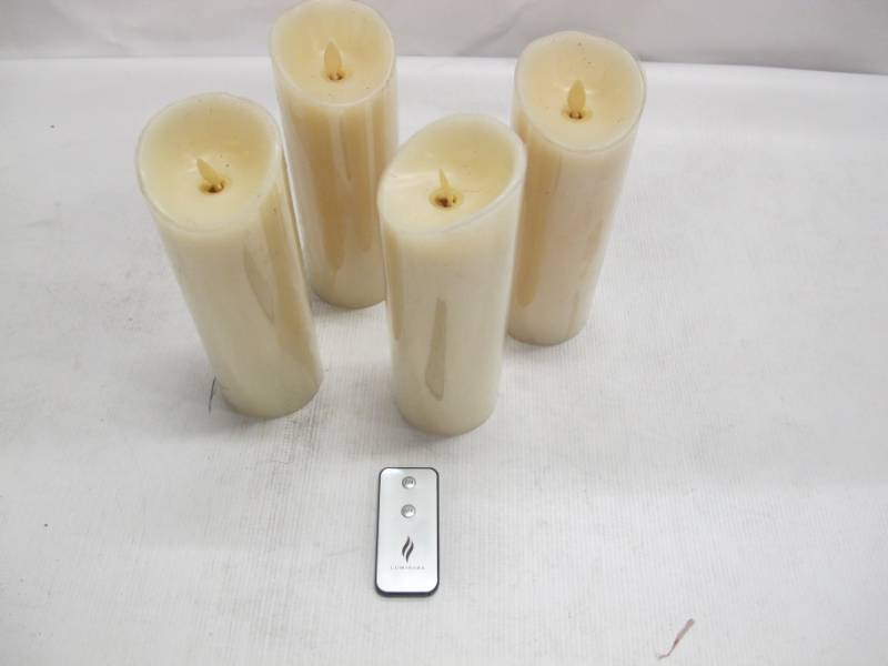 lot 32 image: Luminara Flameless Candles Vanilla Scented Ivory Pillar, 9 inches Set of 4