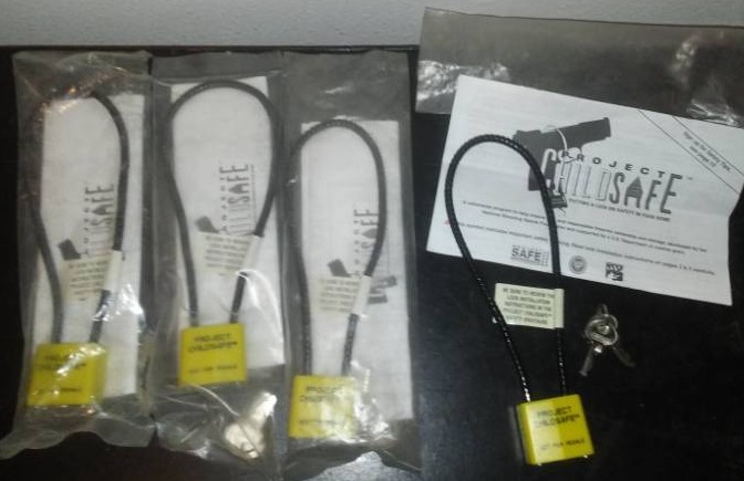 lot 242 image: Four new child safe Gun trigger locks each with two keys.