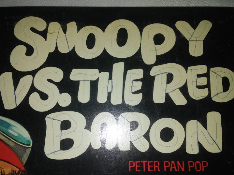 lot 277 image: Two albums - snoopy versus the Red Baron and men in the Green Beret