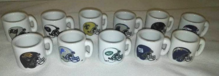 lot 34 image: 11 - NFL porcelain helmet tiny mugs. $55 value.