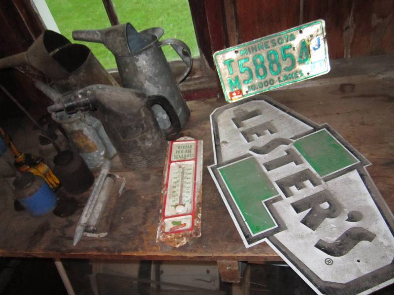 lot 90 image: Signs and oil cans...