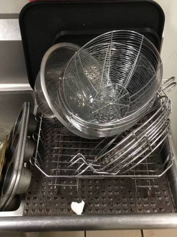 Dish rack dish mats 2 heavy duty muffin pans 1 small one various baskets and strainer plus more.
