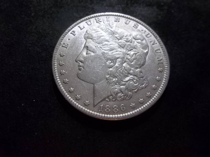 lot 33 image: 1886 O Morgan Silver Dollar