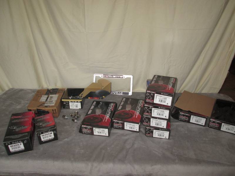 lot 235 image: Lot of Corvette lug nuts, brake pad...