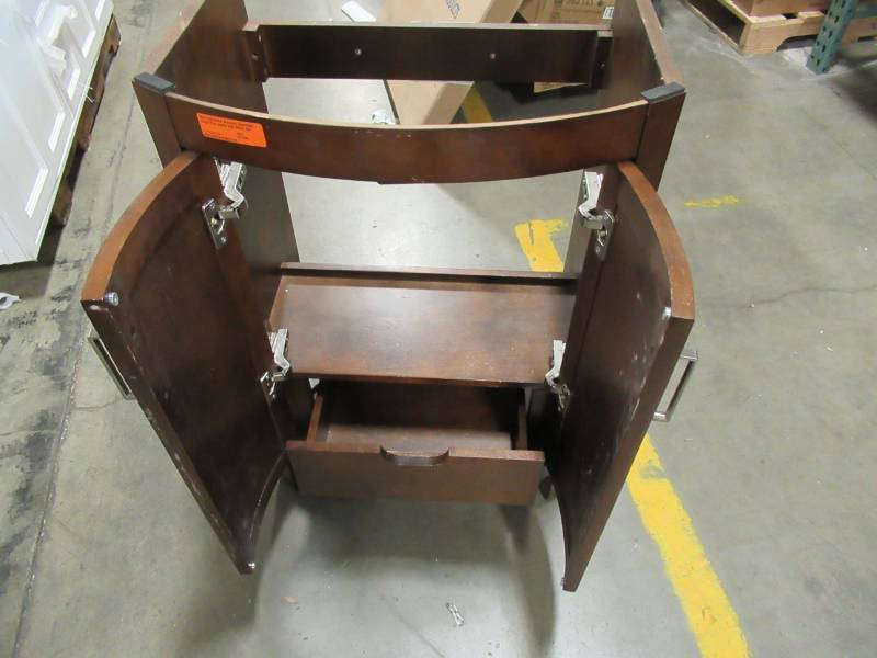 lot 257 image: Style Selections Morecott Chocolate Single Sink Vanity Cabinet, 1142VA-24-220 measures 22 12 X 17 X 33 Tall.