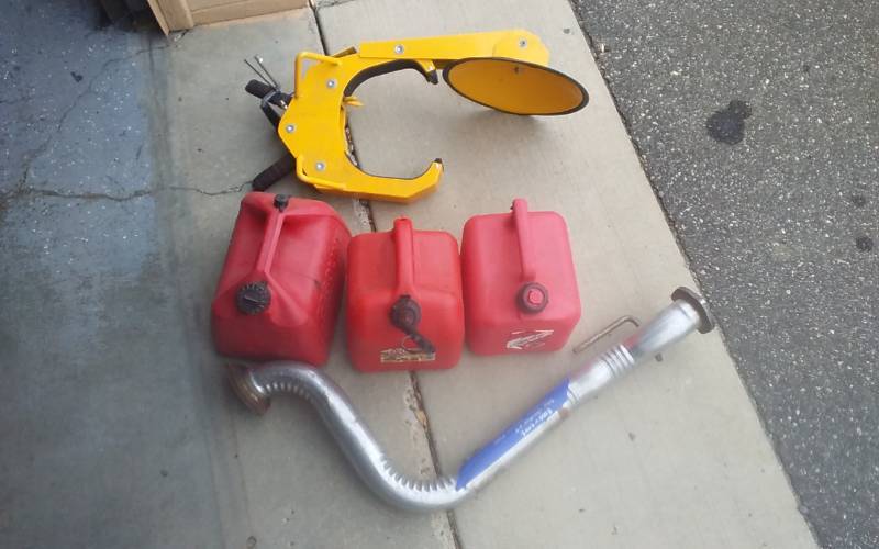 lot 53 image: Car Tire Boot With Key, 3-Gas Cans, Jeep Exhaust Pipe