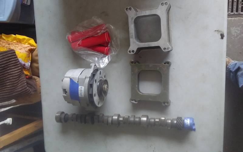 lot 56 image: Chevy Alternator, Comp Cam For SBC, 2-Carb Spacers, 4-Plug Wire Protectors