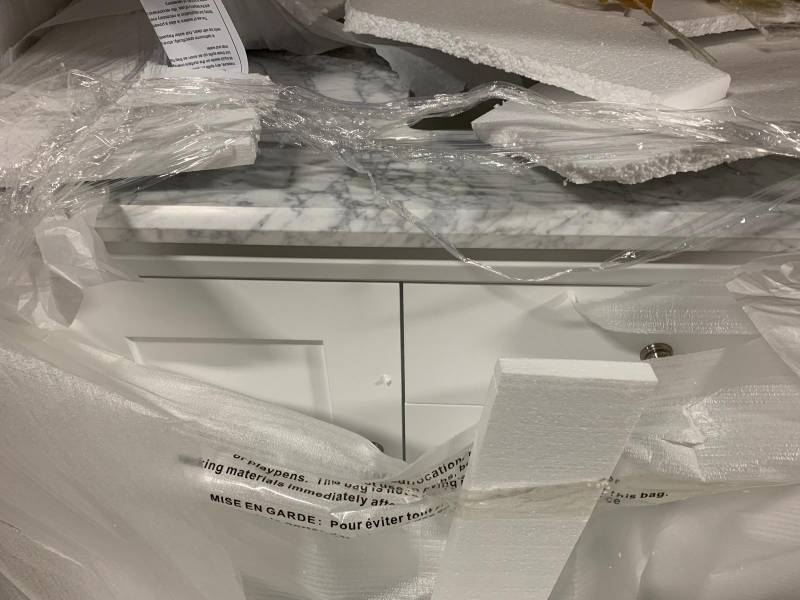 Martha Stewart Living Sutton 48 in. W x 22 in. D Vanity in Bright White with Marble Vanity Top in WhiteGrey with White Basin whit damage on the bottom shelf please review the photos