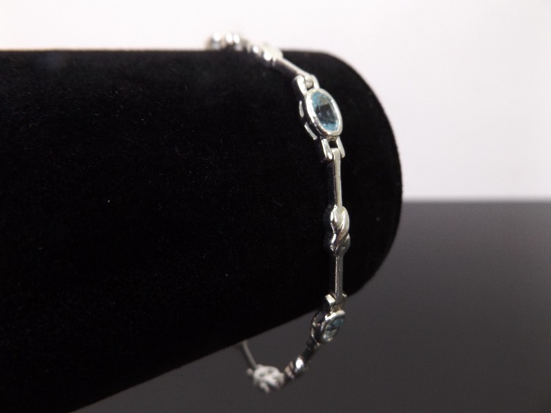 lot 56 image: .925 Sterling Silver Faceted Topaz Tennis Bracelet