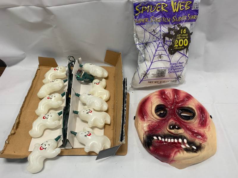 lot 62 image: Halloween Rubber Mask, Lights, and Spider Web