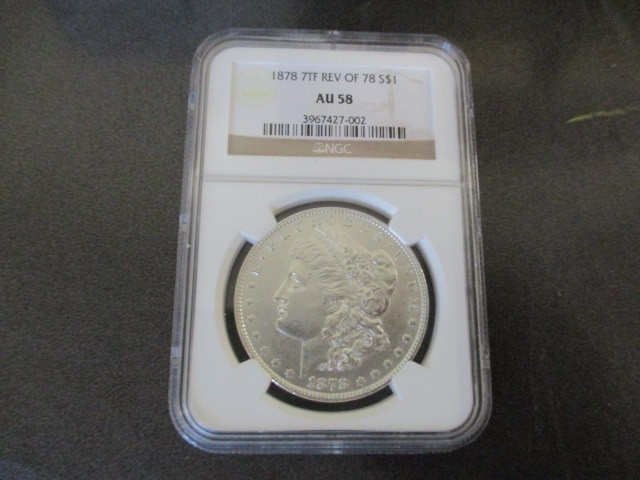 NGC Certified AU58 1878 7 Tail Feather Reverse of 78 Morgan Silver Dollar.