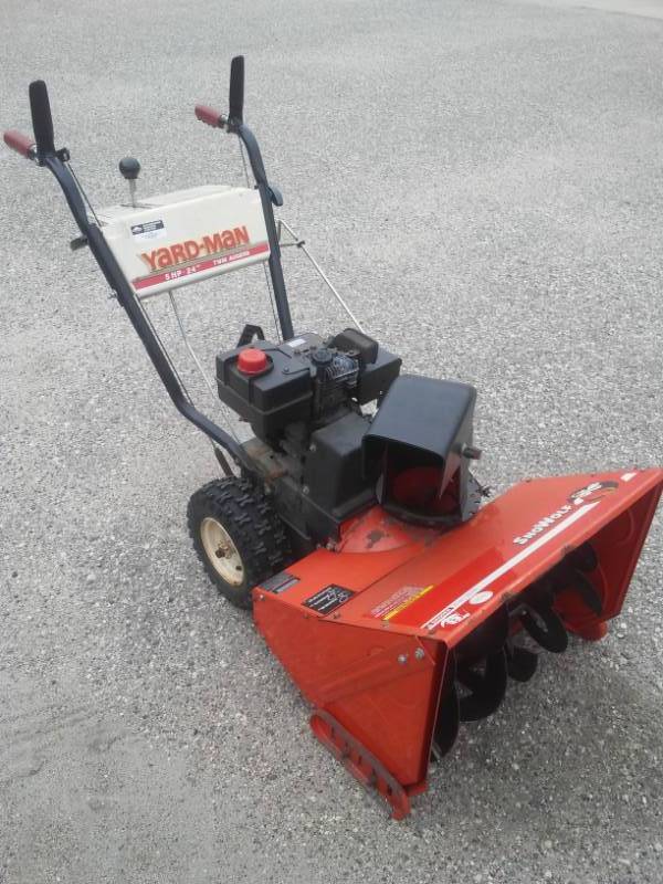 lot 221 image: Yard-Man 5 HP 24 cut twin auger snowblower - SnoWolf
