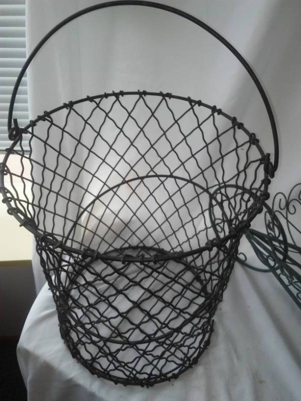 lot 306 image: Wire basket and wheelbarrow plant stand.