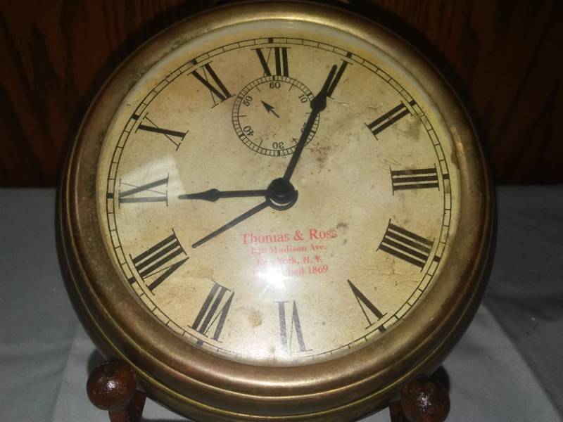 lot 410 image: Clock on a stand brass - heavy.