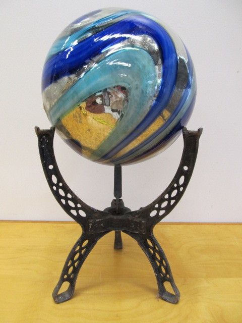 lot 161 image: Blue Swirled Glass Gazing Ball on Antique Cast Iron Base