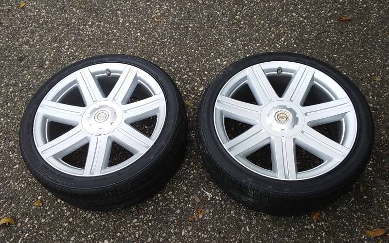 lot 13 image: Pair Of Stock 2005 Chrysler Crossfire Rims & Tires 27540 R-18