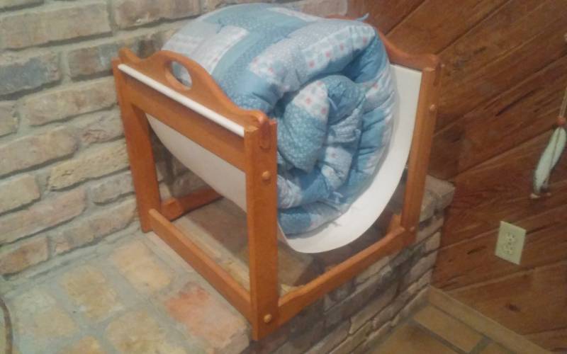lot 28 image: Wood Frame Log Holder Rack (Clean) & Patchwork Quilt