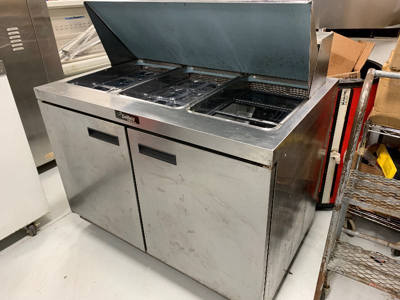 lot 32 image: Delfield 2 Door Prep Table Table Mod 4448N-18MDimensions 48 x 31.5 x 42115 VoltsRuns Cools